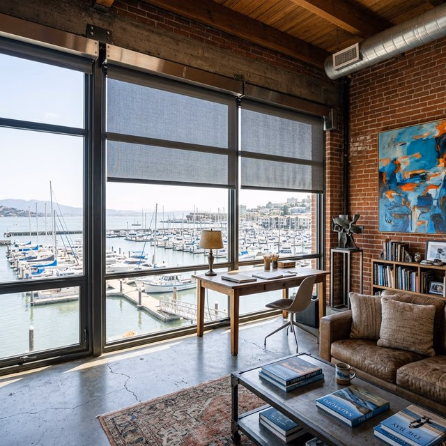 Motorized solar shades on large windows in a Sausalito studio, installed by Bay Blinds, Novato CA 94945