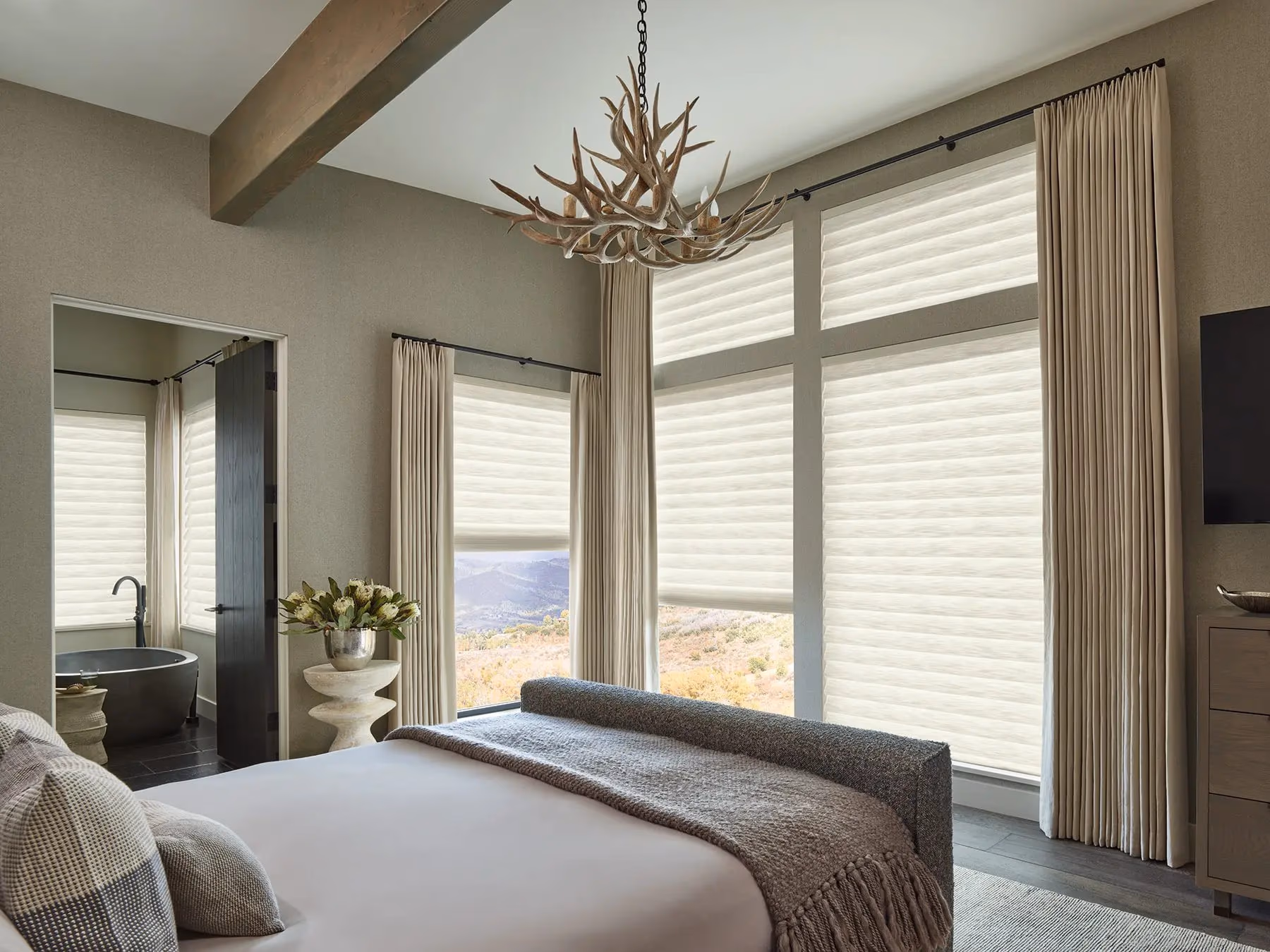 Hunter Douglas Aura illuminated shades in a roman configuration producing a soft ambient glow in a Marin County bedroom, installed by Bay Blinds Novato CA 94945