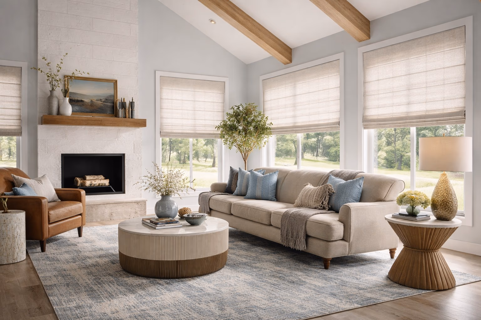 Hunter Douglas Roman Shades on multiple windows in a modern farmhouse living room with vaulted beam ceiling white brick fireplace and blue pillows, installed by Bay Blinds