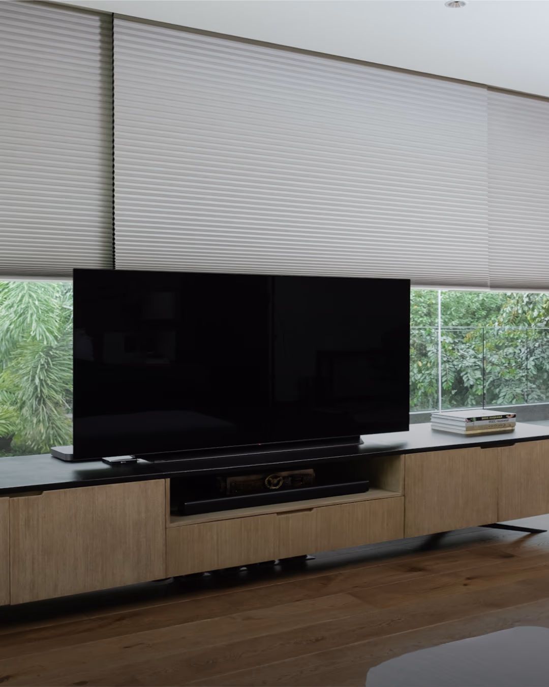 Hunter Douglas honeycomb cellular shades for thermal insulation behind a living room console in a San Rafael whole-home retrofit
