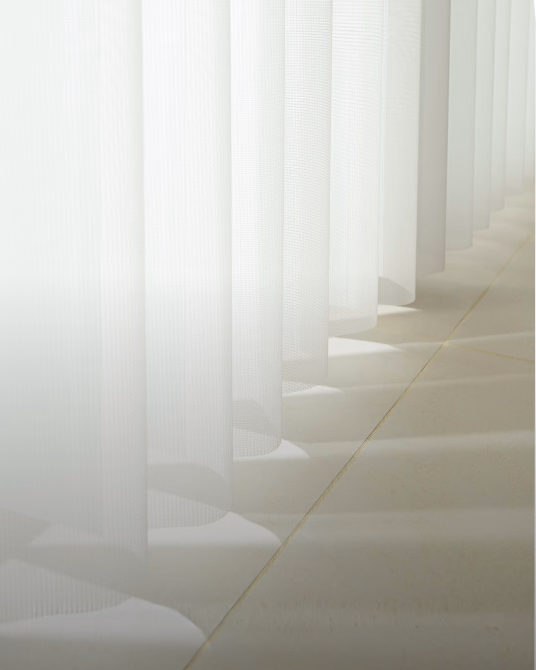 Track-mounted floor-length drapery hardware detail with motorized operation, installed by Bay Blinds, Novato CA 94945
